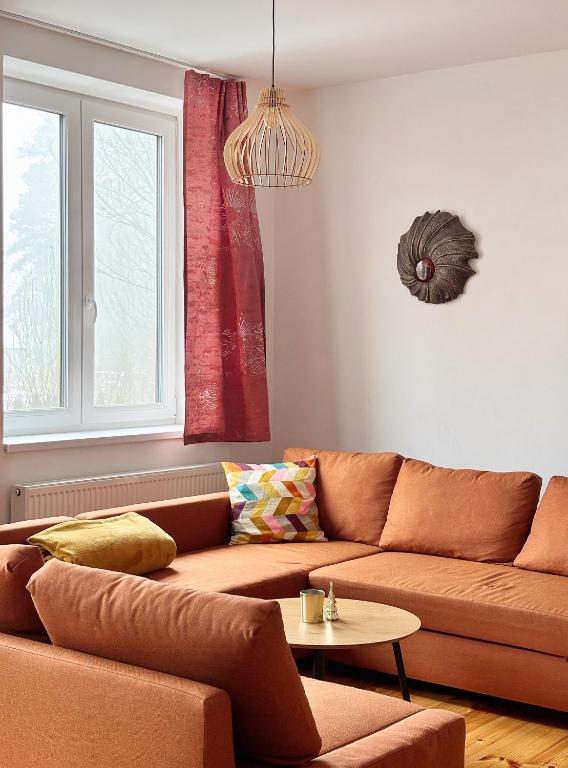 a living room with a couch and a table at Apartment Kundratice in Košťálov