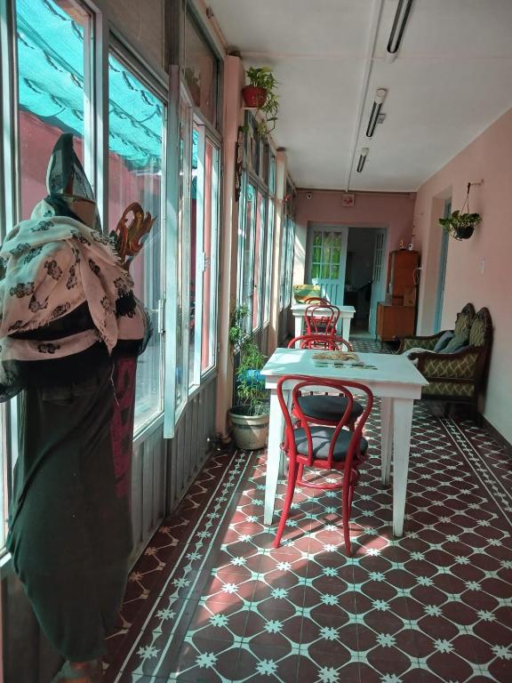 a room with a table and a chair in a room at La Casona Hostel in Bermejo