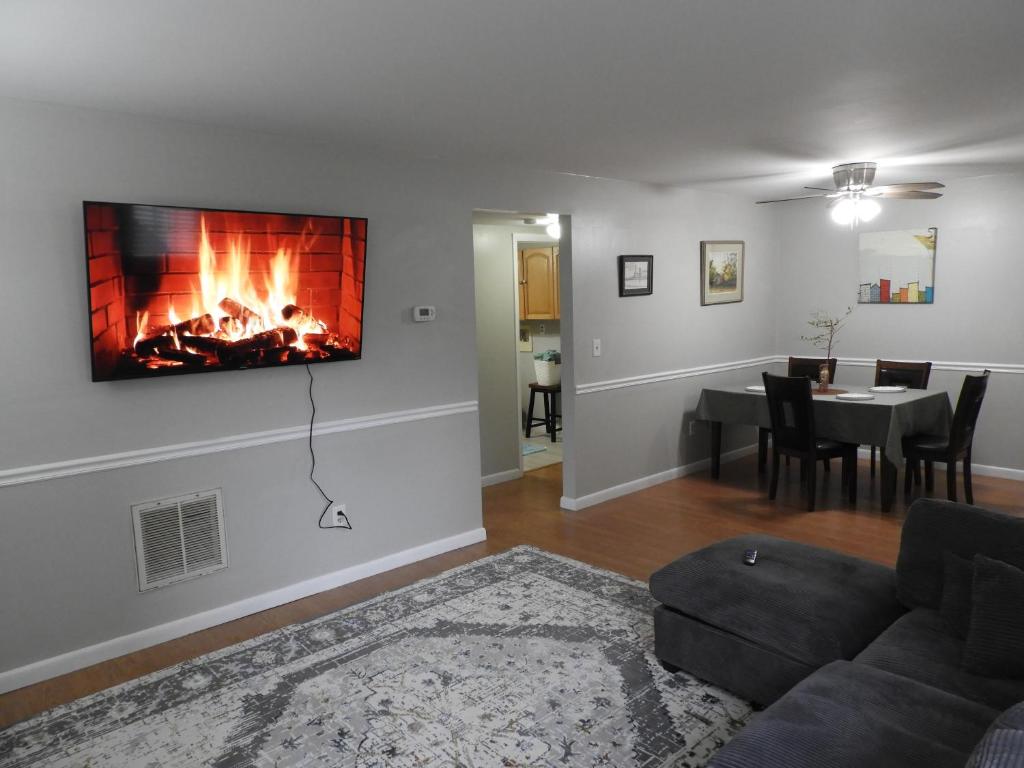 a living room with a couch and a fireplace at CONDO 101c in Camp Hill
