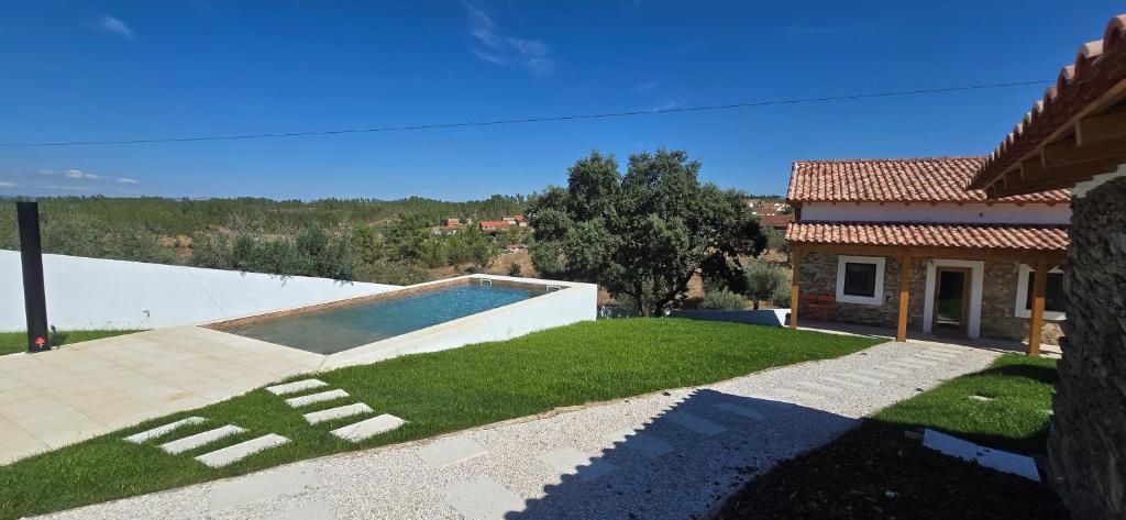a villa with a swimming pool and a house at Casa da Picoteira - Pool - Pets - EV Charger in Proença-a-Nova