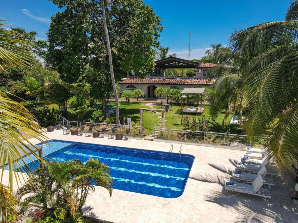 a swimming pool in front of a house at Amara Hotel in Doradal