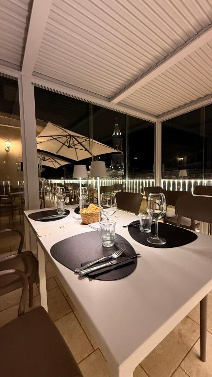 a white table with glasses and napkins on it at GOLA Dimora storica in Cerignola