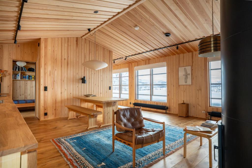 a living room with a table and a chair at Kalamaja Kilpisjärvi in Kilpisjärvi