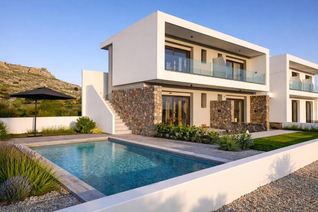 a house with a swimming pool in front of it at Haraki Emerald in Haraki