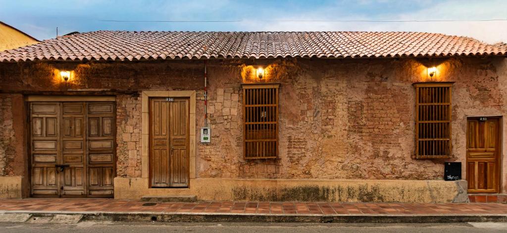 a brick house with two doors and a tile roof at Casa Orígenes Hotel Boutique in Pamplona