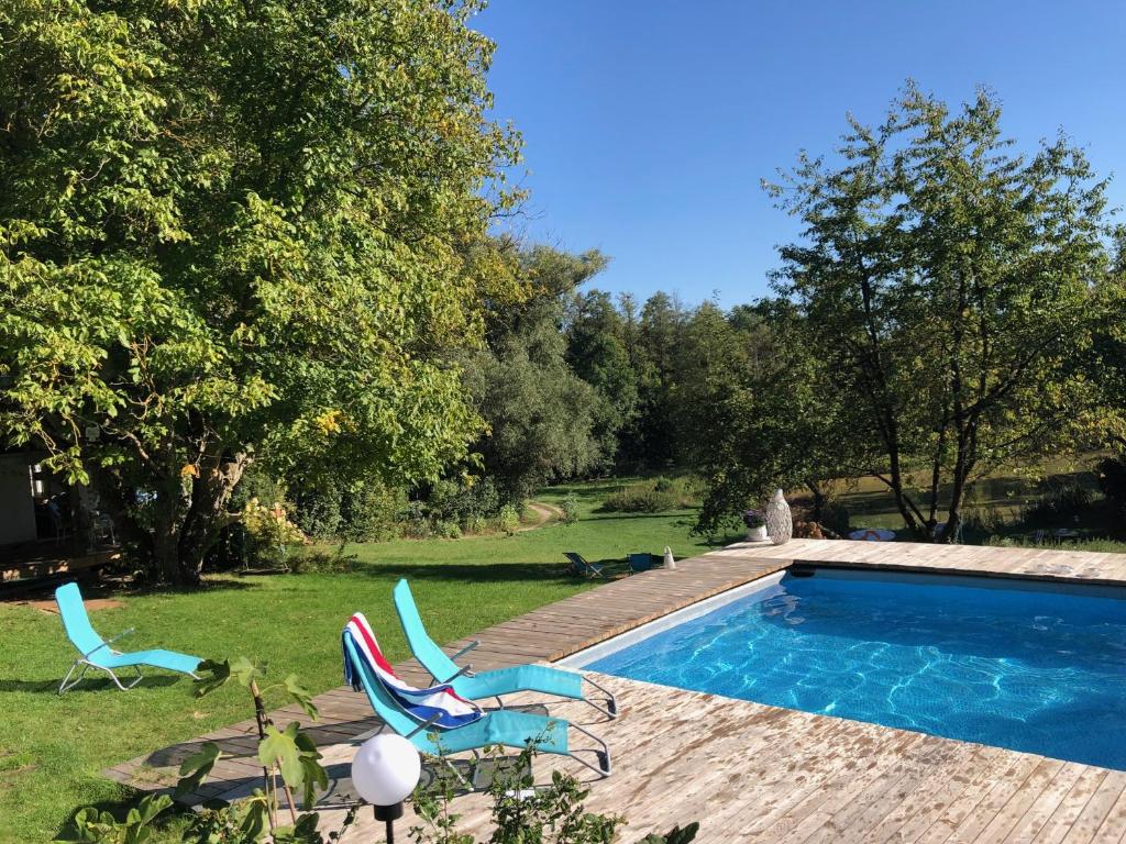 a yard with two chairs and a swimming pool at Cottage house Lublin in Lublin