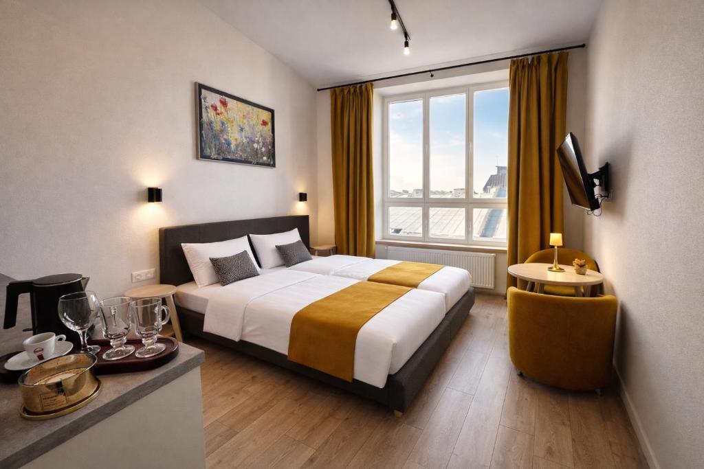 a hotel room with a bed and a large window at Apart-HOTEL GALLERY 21 in Lviv