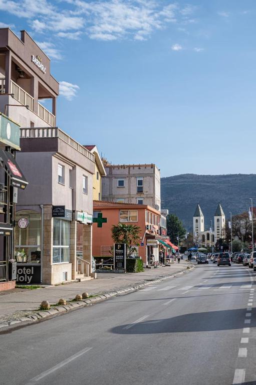 an empty street in a small town with buildings at Hotel Holy Miracle in Međugorje