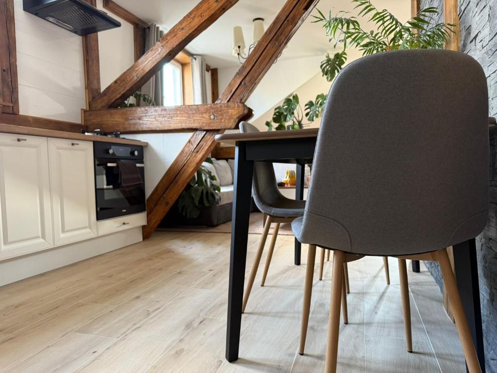 a dining room with a table and a chair at Studio Lec in Giżycko
