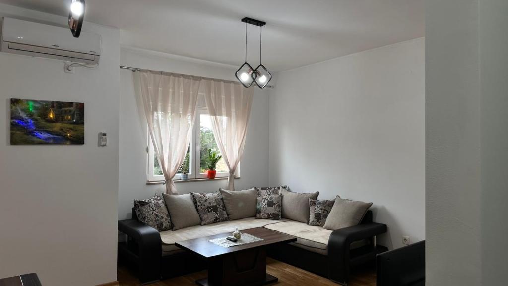 a living room with a couch and a table at Rest apartment Niksic in Nikšić