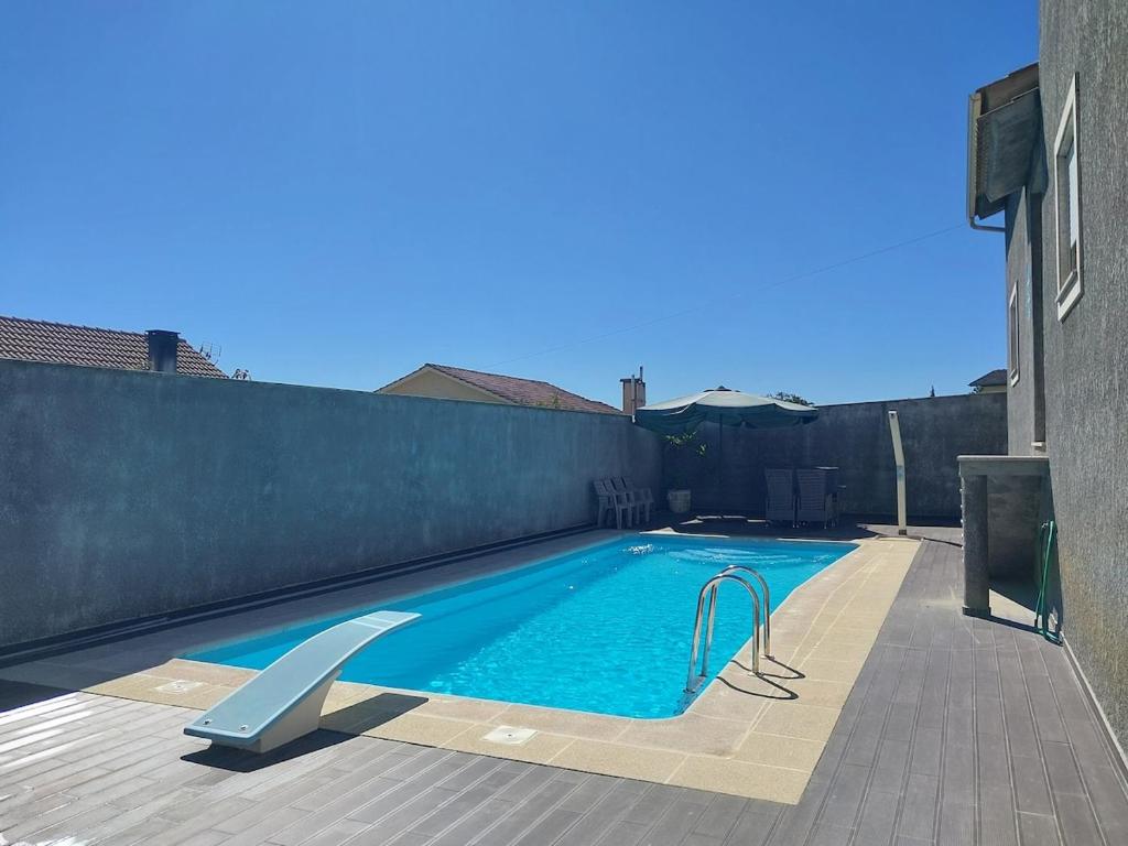 a small swimming pool with a fence at Casa Flamingo in Viseu