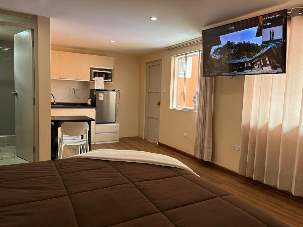 a bedroom with a large bed with a flat screen tv at Gran Estancia Vallecito in Arequipa