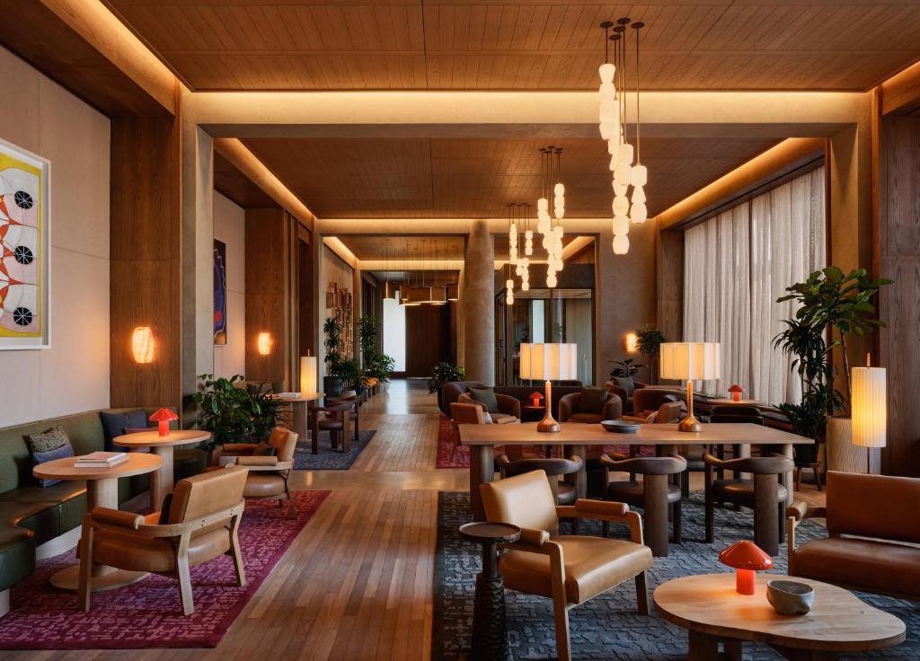 a lobby of a hotel with tables and chairs at The Atlas Hotel in Boston