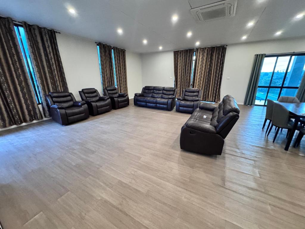 a room with couches and a table and chairs at Reddy Homes in Lautoka