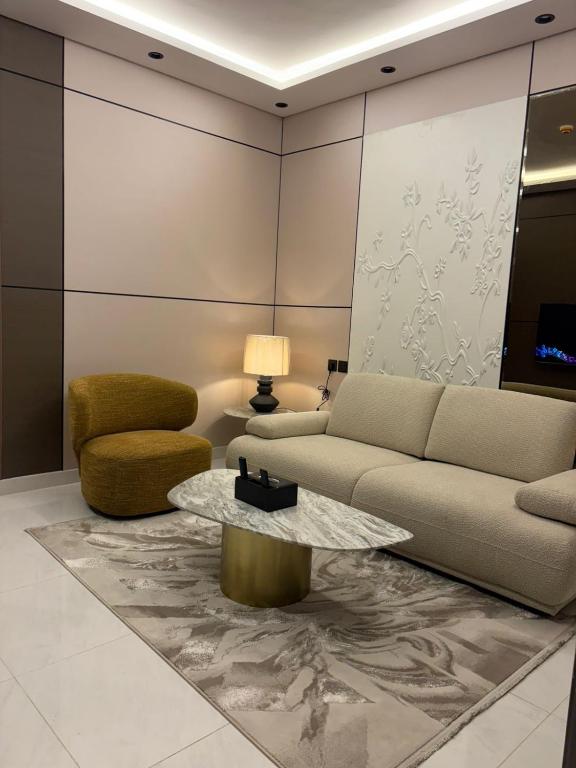 a living room with a couch and a table at Pure Stay House in Taif