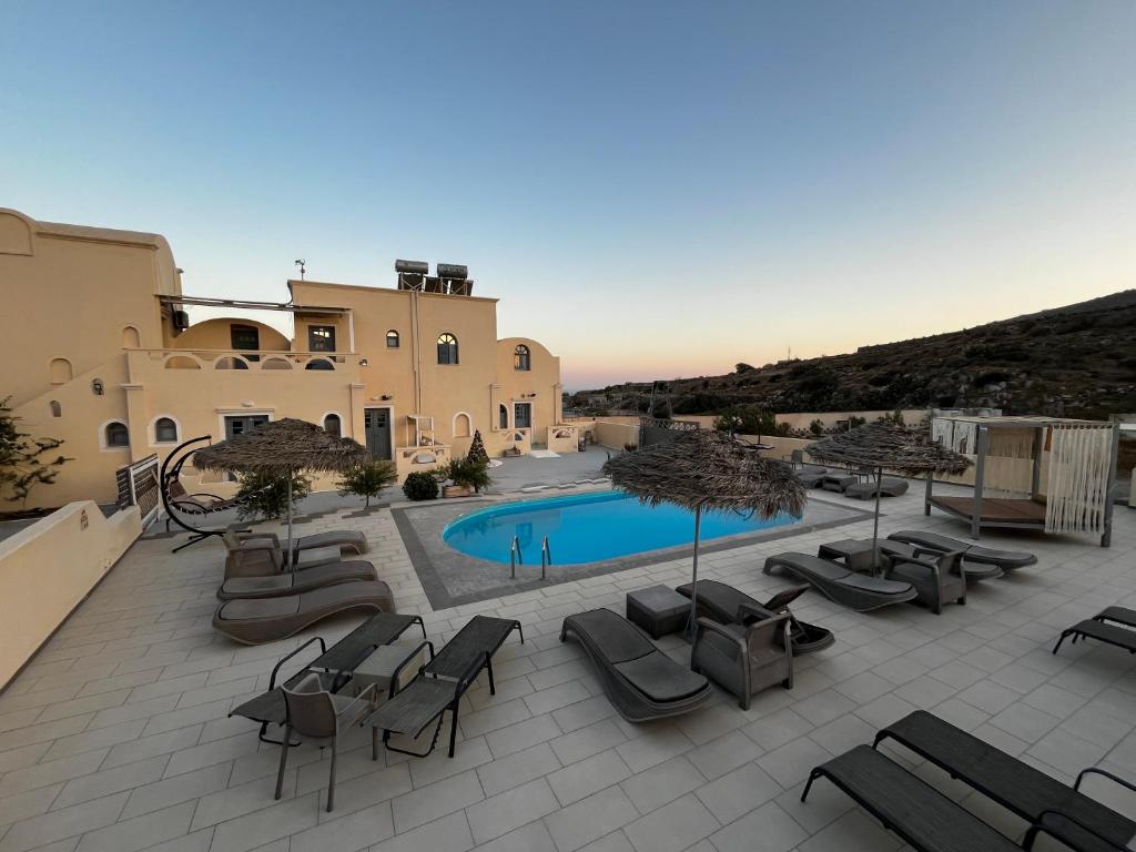 a view of a patio with chairs and a pool at Leon Lux Apartment in Perivolos