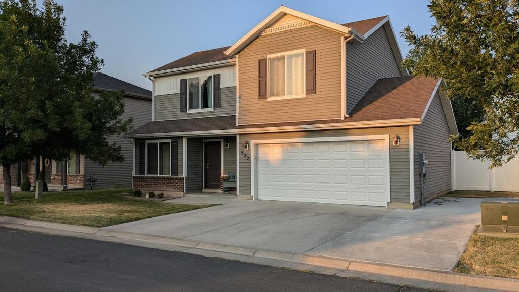 a house with a white garage door at Central Mountain Retreat - Sleeps 7! in Logan