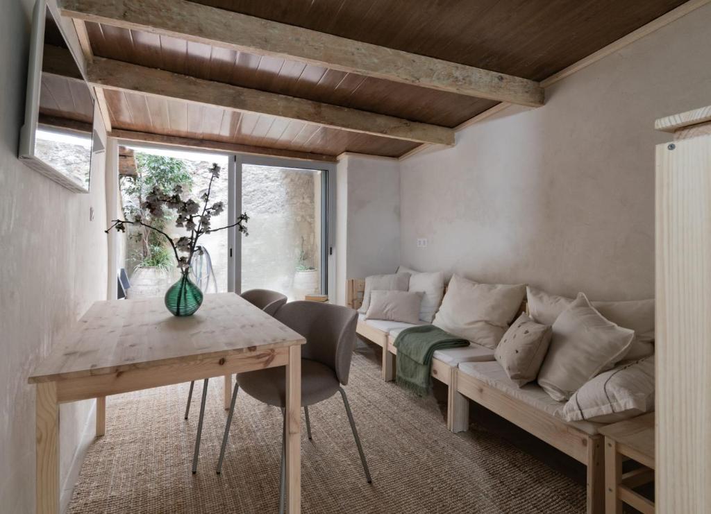 a living room with a couch and a table at Calderona Tiny house in Segorbe