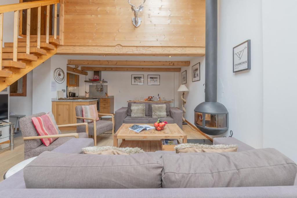 a living room with a couch and a fireplace at Apt Clusettes 1-min walk to ski + parking & WiFi - Happy Rentals in Chamonix