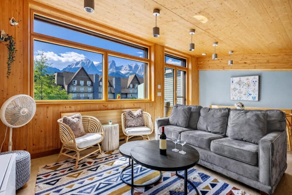 a living room with a couch and a table at Dolomites #203 - LEED Gold Certified in Canmore