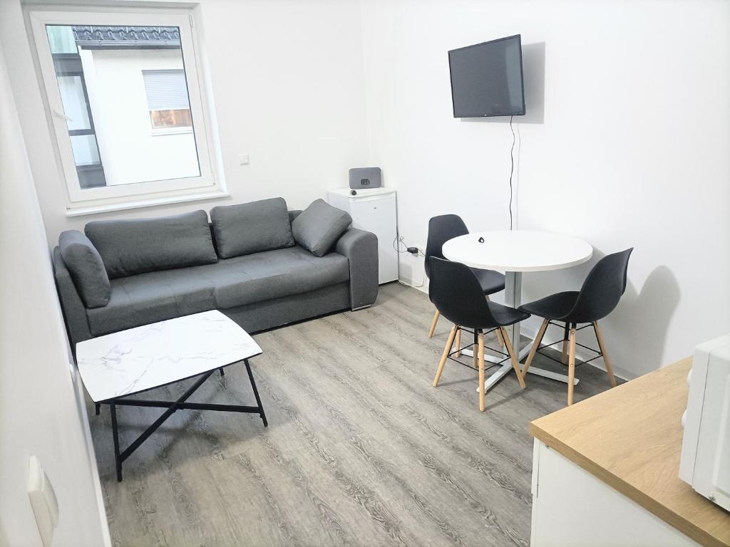a living room with a couch and a table at Waldstreet in Rüsselsheim