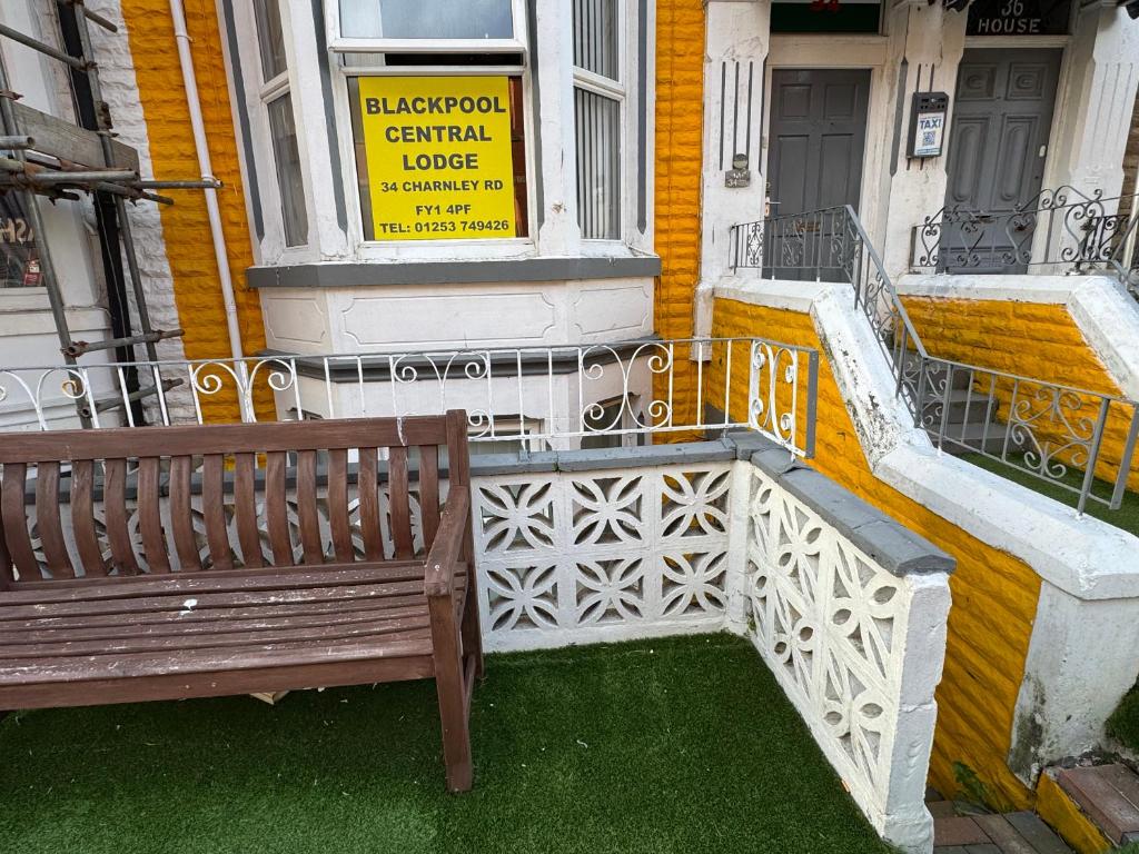 a wooden bench in front of a building at Blackpool Central Lodge in Blackpool