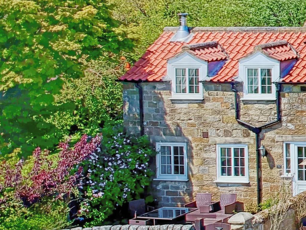 an old stone house with a red roof at Smugglers View Nr Whitby in Ravenscar