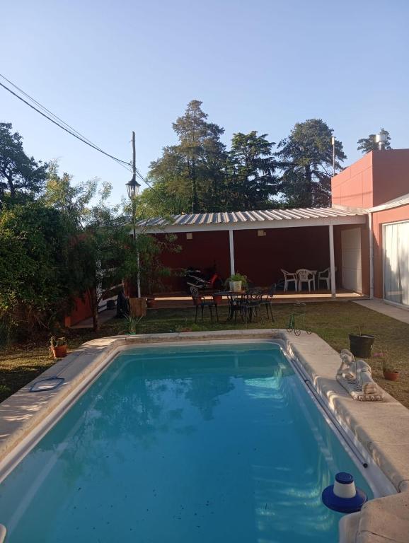 a large blue swimming pool in front of a house at Espacio Armonia Junin Balneario in Junín