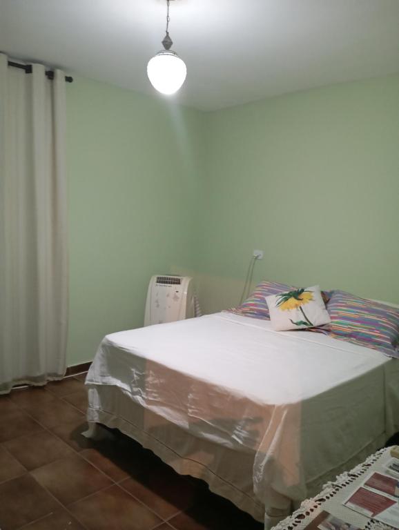 a bedroom with a bed with a light on it at hospedagem quarto n3casa da Waldir maria in Goiás