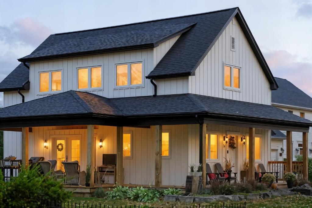 a large white house with a black roof at Spruce Suite Historic NOTL - VINEYARD RETREAT in Niagara-on-the-Lake