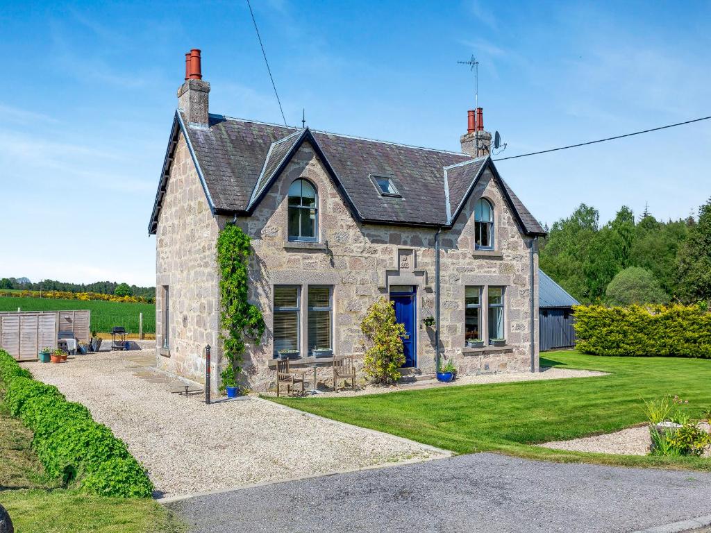 a large stone house with a blue door at The Laurels in Nairn