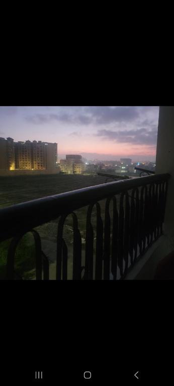 a balcony with a view of a city at dusk at one room in Alexandria