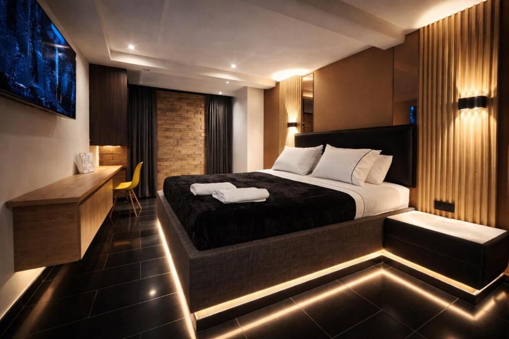 a bedroom with a bed and a desk with lights at Hotel Biba Life - Chia in Chía