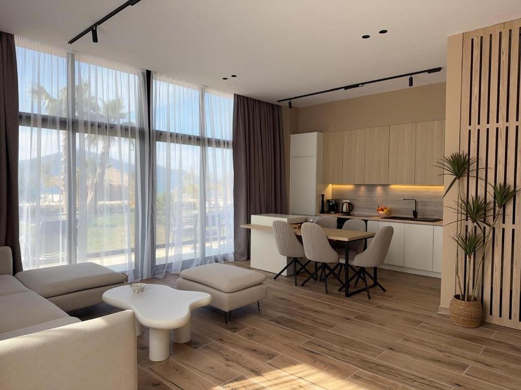 a living room with a couch and a table at Elite Sunset Residence in Vlorë
