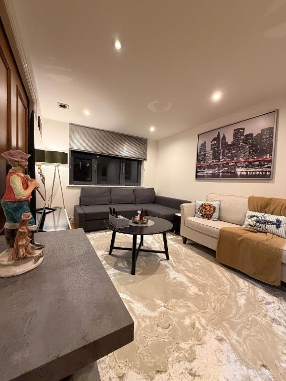 a living room with a couch and a table at VIP apartment paddington in London
