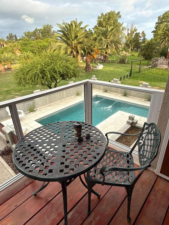 a table and chairs on a deck with a pool at Don Isidro in Miramar
