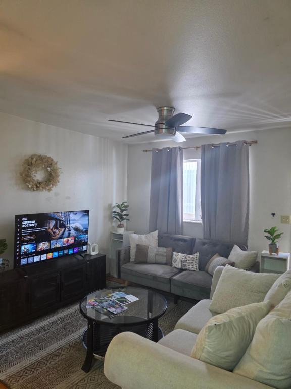 a living room with couches and a flat screen tv at RJN in Fairbanks