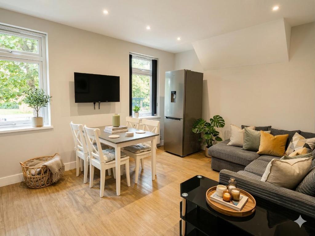 a living room with a couch and a table at Central 3 beds with parking in Reading