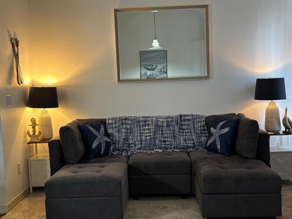 a living room with a couch and two chairs at Branson Lakeside Getaway in Branson