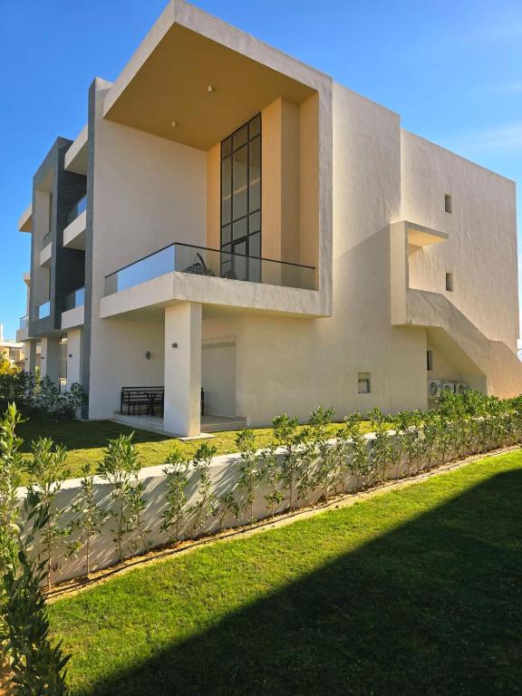 a large white building with a staircase in front of it at Luxury Azha Ain Sokhna Villa - Pool & Garden Views in Ain Sokhna