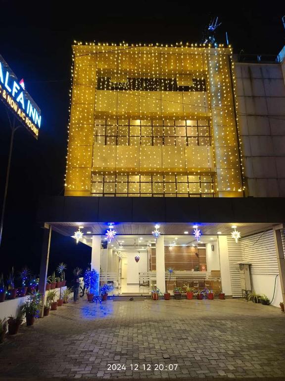 a building with a lot of lights on it at Alfa Inn in Nedumbassery