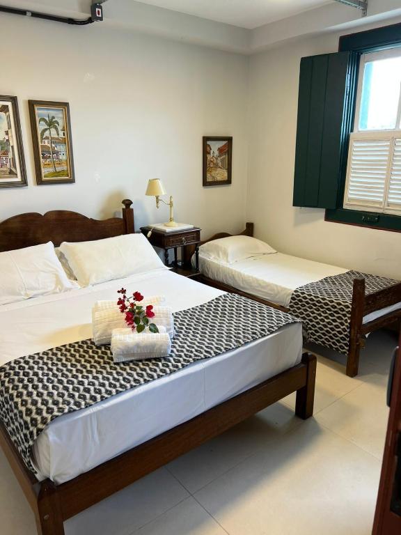 a bedroom with two beds with flowers on it at Loft Macau in Diamantina