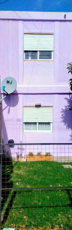 a surfboard sitting on the side of a building at El Jacaranda in Carmen de Patagones