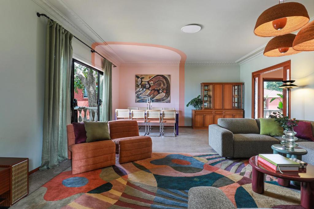 a living room with a couch and a table at Thirroul Beach Apartments in Thirroul