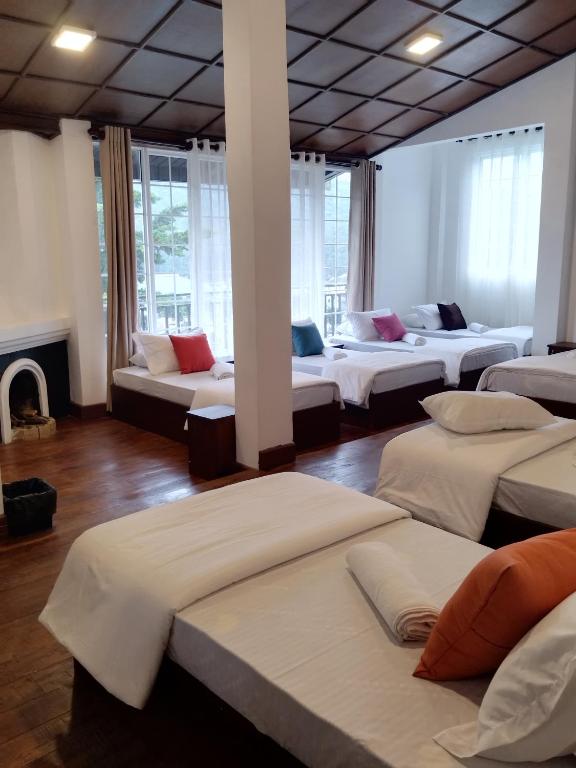 a room with a bunch of beds in it at Star Gate Hostel in Nuwara Eliya