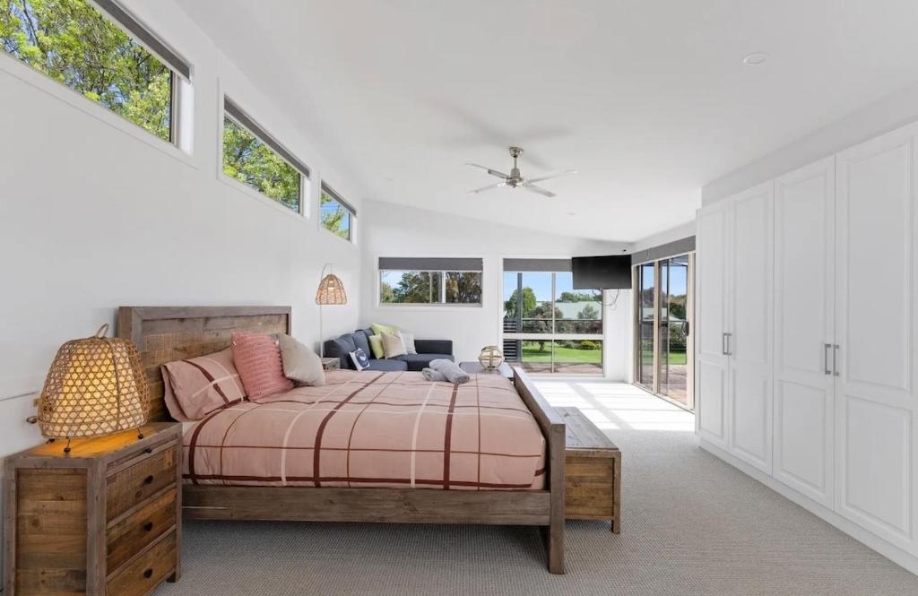 a bedroom with a bed and some windows at Large Pet Friendly Island Escape in Newhaven