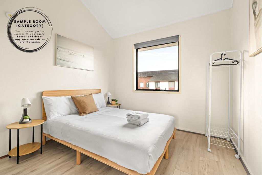 a small bedroom with a bed and a window at Tranquil Double Room - Walk to Train & Cabramatta Eats - Shared Bathroom in Cabramatta
