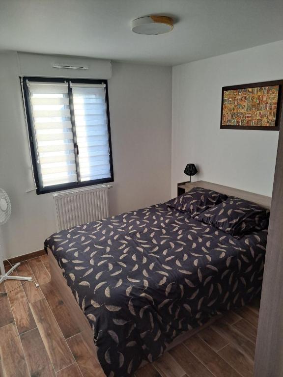 a bedroom with a bed and a window at Chez Cess in Chouilly