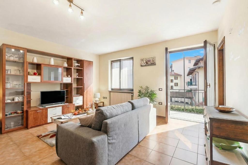 a living room with a couch and a tv at Sunset in Baveno: 1 Bed with Balcony - Happy Rentals in Baveno