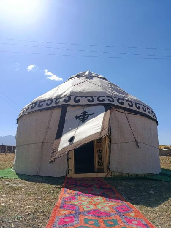 a large dome tent with a door in a field at eco house "QUMUSH YURT" in Emgekchil